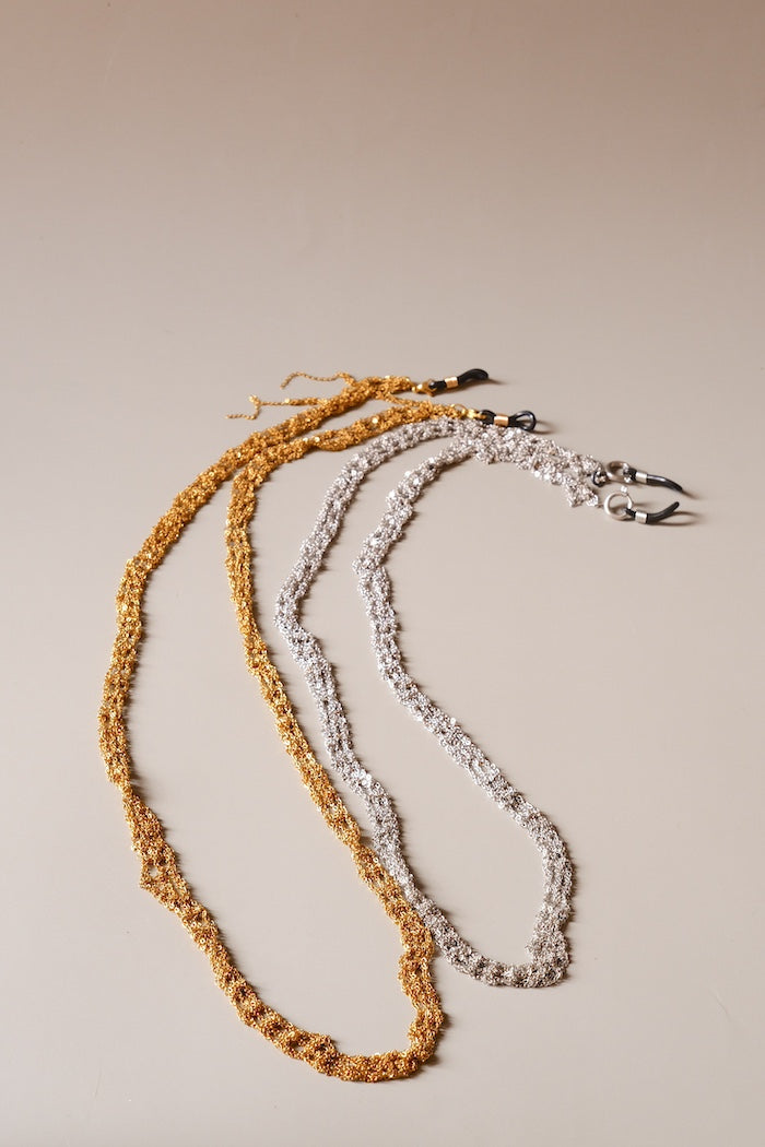 Two necklaces, one gold and one silver, hand crochet chain. Eye wear chain. Barcelona fashion design. Barcelona sudio